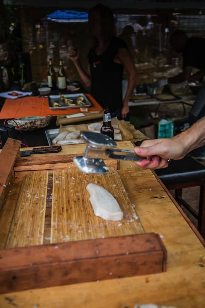 pounding abalone on a cutting board
