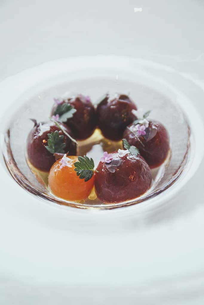 a dish of orange and red balls