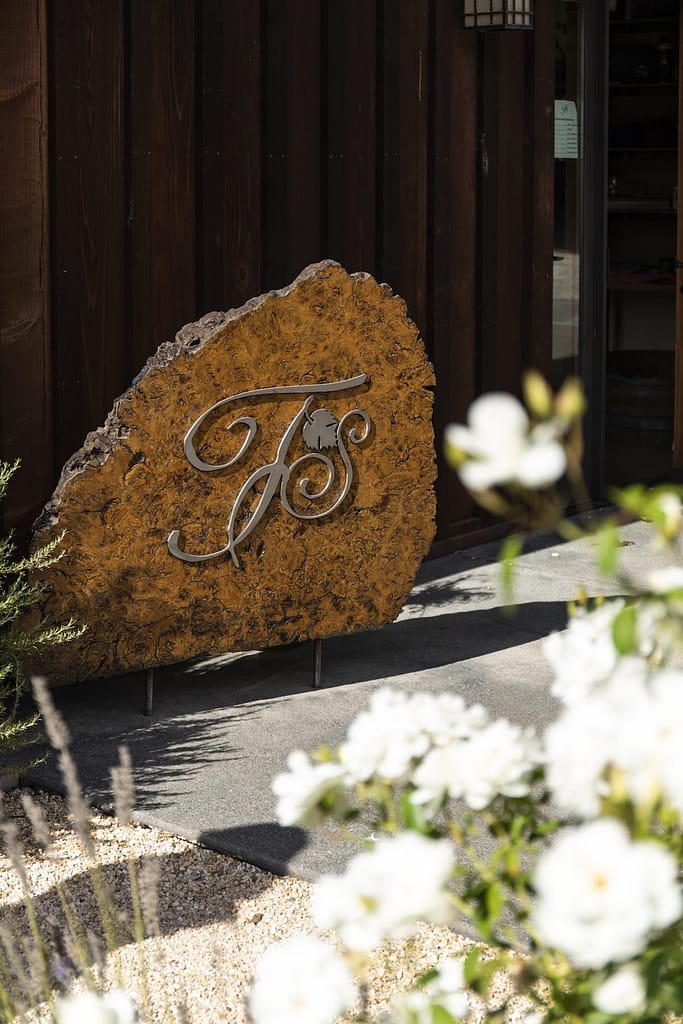 the Foursight Wines wooden sign next to flowers