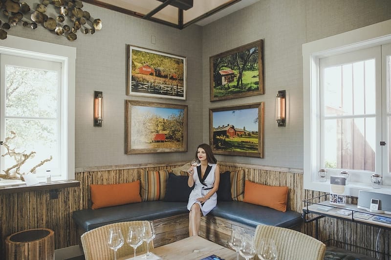 a woman sitting in the corner of the tasting room