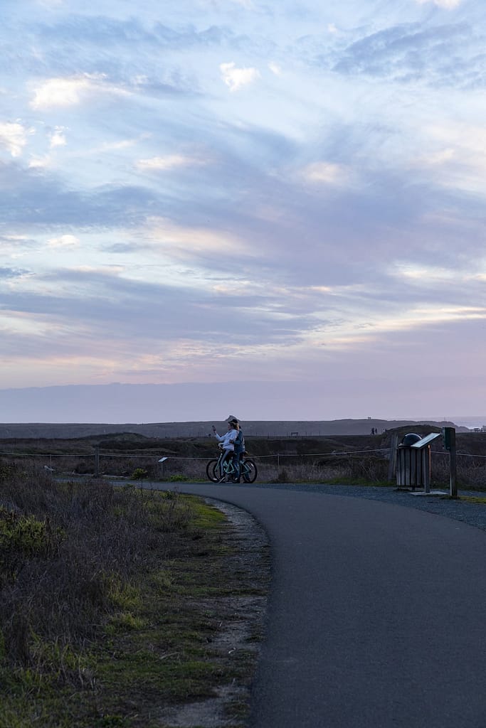 bike riders taking a photo at sunset
