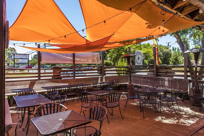 view of outside seating under orange shade cloths