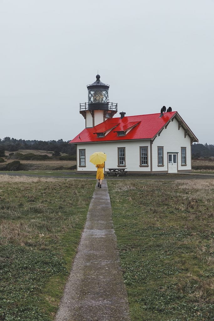 a woman on path to the lighthouse
