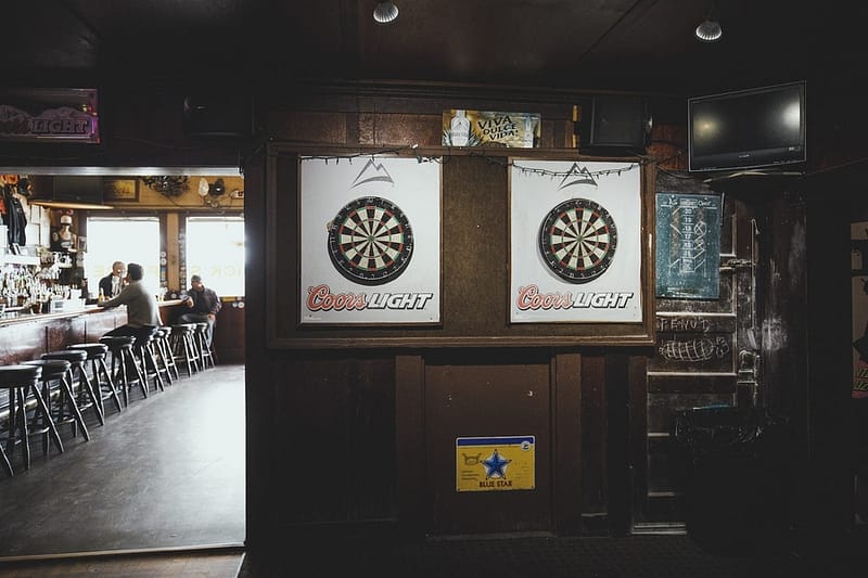 two dart boards in the backroom of the bar