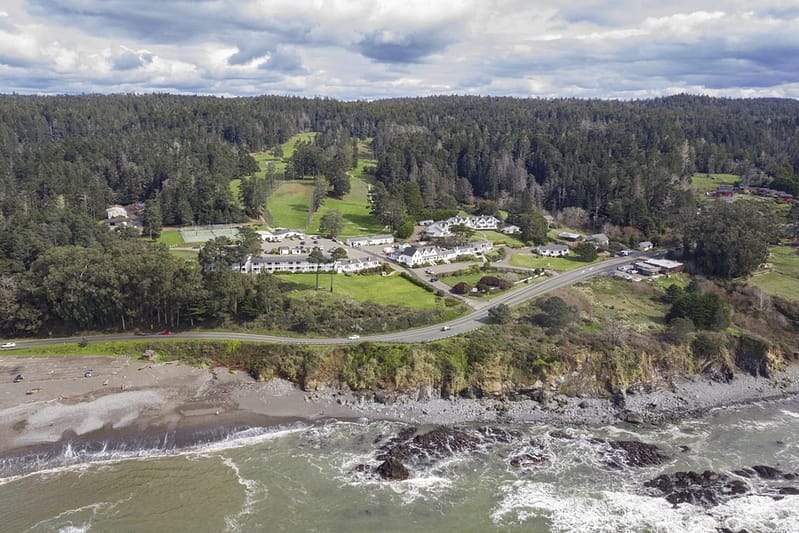 aerial view of the Little River Inn with the ocean in front and the golf course behind