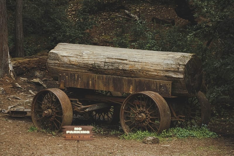 a large log on an antique rusty cart