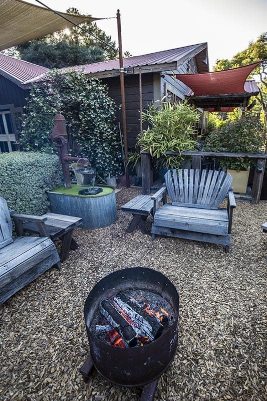 outdoor seating with benches and wood fire pit