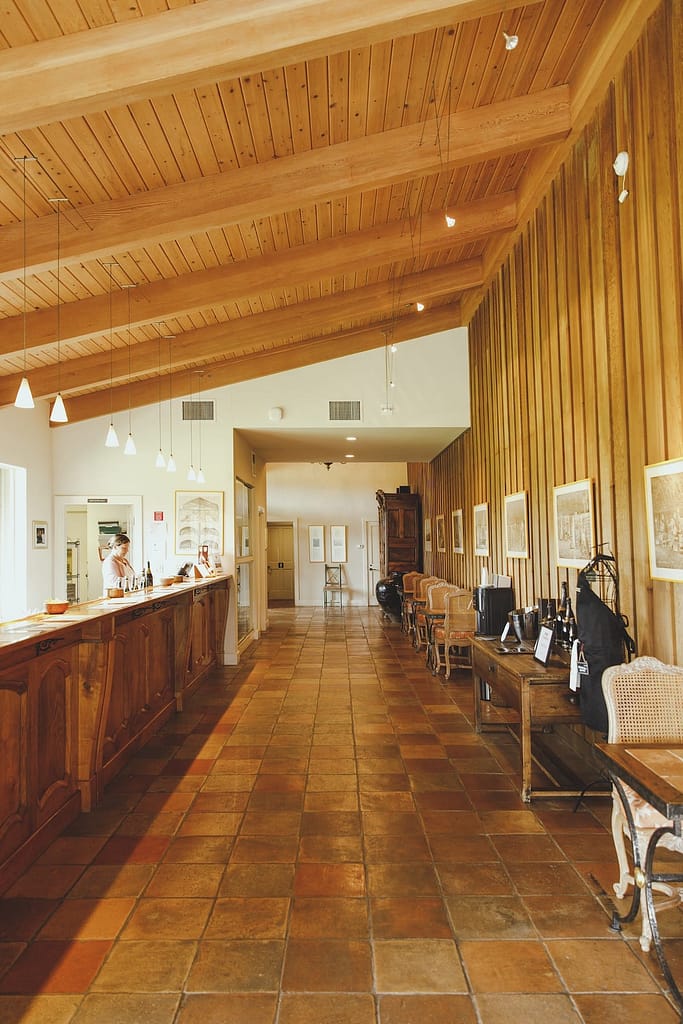 a tasting room with wooden bar and tiled floor