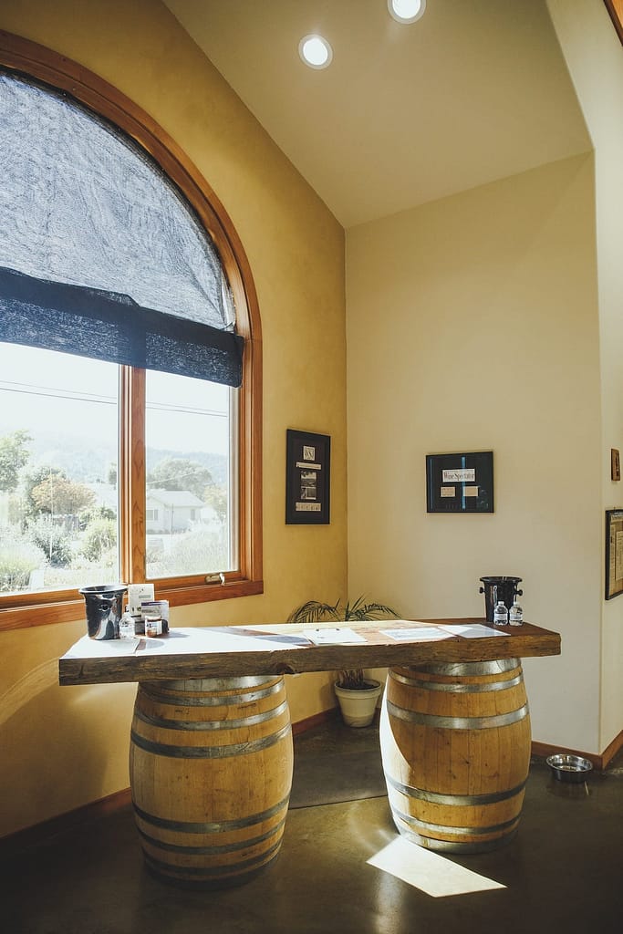 a table made of two wine barrels in the tasting room
