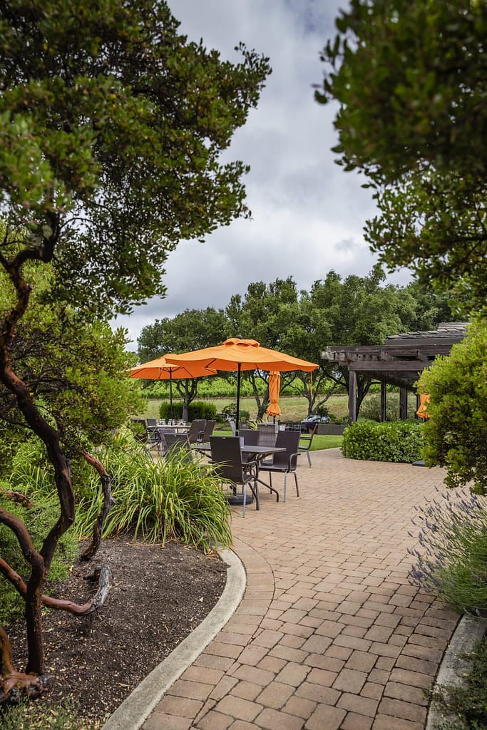 orange umbrellas above picnic tables in the garden