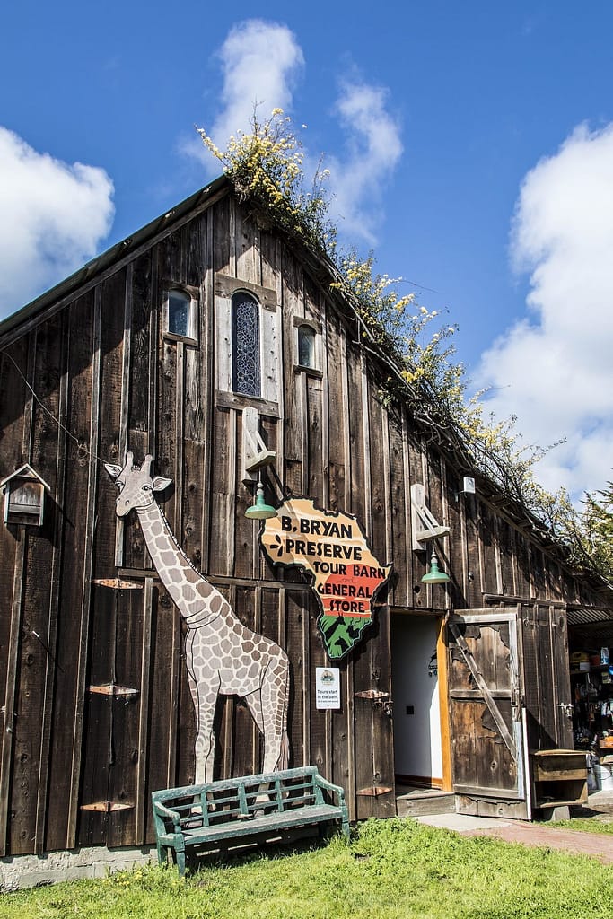 a wooden barn decorated with a giraffe cutout