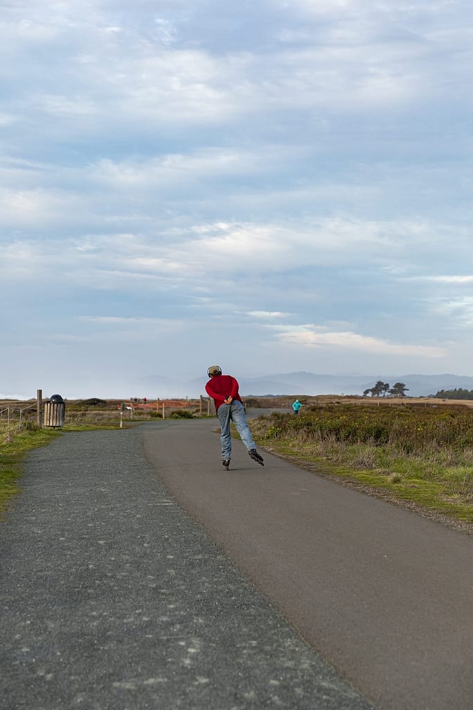 a man rollerblading on a path